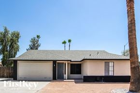 Glendale house for rent - A house with a palm tree in front of it.
