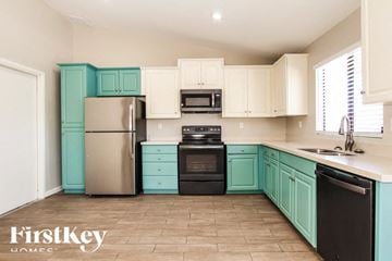 Glendale house for rent - A kitchen with a black dishwasher and black oven.