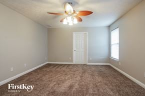 Indianapolis house for rent - a bedroom with carpet and a ceiling fan
