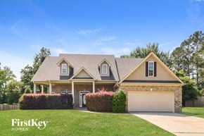 Mcdonough house for rent - a single story home with a garage and a lawn