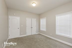 Mcdonough house for rent - a bedroom with two doors and a carpeted floor