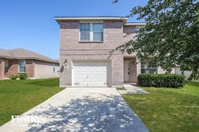 San Antonio house for rent - A brick house with a white garage door in front.