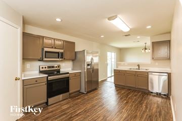 San Antonio house for rent - A kitchen with wooden floors and stainless steel appliances.