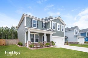 Summerville house for rent - a house with blue siding and a lawn