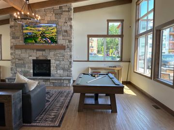 Missoula apartment for rent - A living room with a fireplace and a tv mounted above it.