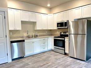 Missoula apartment for rent - A kitchen with white cabinets and stainless steel appliances.