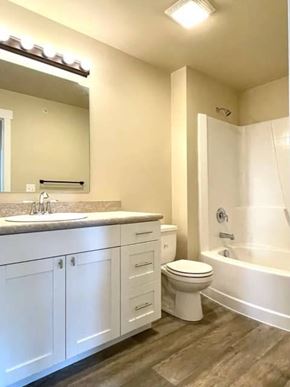 Missoula apartment for rent - A white bathroom with a sink, toilet, and bathtub.