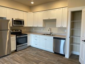 Missoula apartment for rent - A kitchen with white cabinets and stainless steel appliances.