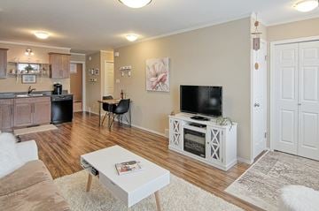 Saskatoon apartment for rent - A living room with a white coffee table and a television on a stand.