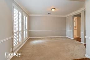 Houston house for rent - a living room with a carpeted floor and large windows