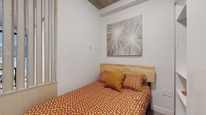 Edmonton apartment for rent - a bedroom with a bed and a painting on the wall