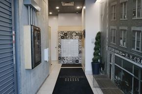 Edmonton apartment for rent - the entrance to the lobby of a building with a black and white door