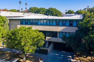 Los Angeles apartment for rent - an aerial view of a building with trees and a parking lot