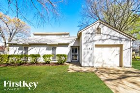 Collierville house for rent - A white house with a garage door numbered 1152 is for sale.