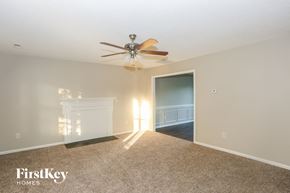 Huntersville house for rent - A room with a carpet floor and a ceiling fan.