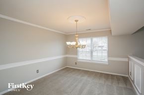 Indianapolis house for rent - A room with a chandelier and a window with blinds.