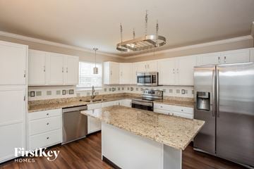 Indianapolis house for rent - A kitchen with granite countertops and stainless steel appliances.
