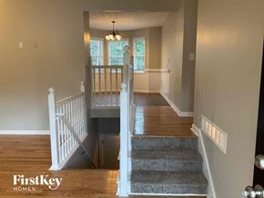 Dallas house for rent - A hallway with a staircase leading to a second floor.