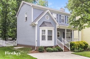 Greensboro house for rent - a blue house with a white front porch and a white fence