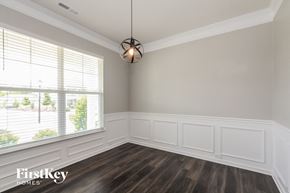 Mooresville house for rent - A room with wooden floors and white walls.