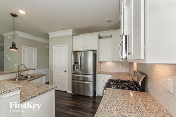 Mooresville house for rent - A kitchen with granite countertops and stainless steel appliances.