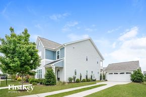 Clayton house for rent - A white house with a garage is for sale.