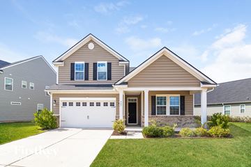 Summerville house for rent - a brown house with a white garage door