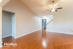 Summerville house for rent - a living room with wood floors and a ceiling fan
