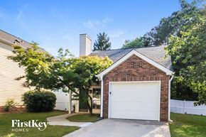Alpharetta house for rent - A brick house with a white garage door is for sale.