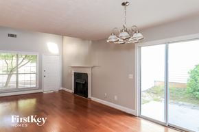 Alpharetta house for rent - A well-lit room with a fireplace and a chandelier.