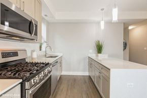 Chicago apartment for rent - a kitchen with stainless steel appliances and white counter tops