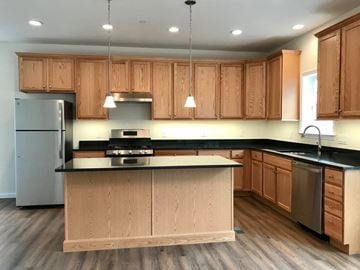 Peekskill apartment for rent - a kitchen with wooden cabinets and stainless steel appliances