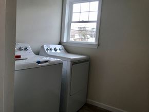 Peekskill apartment for rent - a small laundry room with two washing machines and a window
