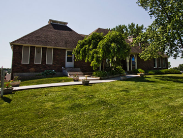 Kansas City apartment for rent - a house with a lawn and a tree in front of it
