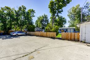 Lafayette apartment for rent - a parking lot with a wooden fence and a car in it