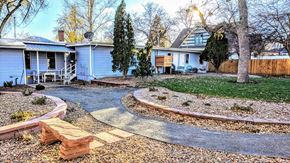 Lafayette apartment for rent - a backyard with a curved walkway and a blue house