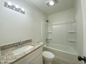 Carencro house for rent - a bathroom with a sink toilet and a shower