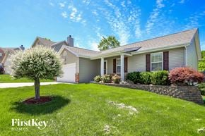 Fenton house for rent - a house with a lawn and a tree in front of it