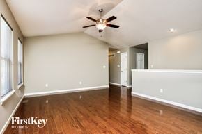 Fenton house for rent - an empty living room with wood floors and a ceiling fan