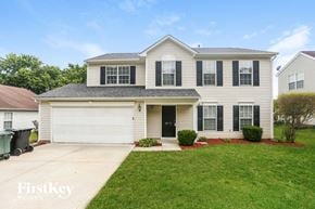 Concord house for rent - A two-story house with a garage and a driveway.