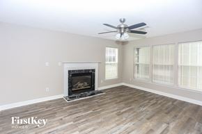 Concord house for rent - A living room with a fireplace and a fan.