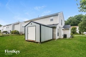 Concord house for rent - A metal shed is in the foreground of a grassy area in front of a house.
