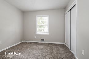 Suwanee house for rent - a bedroom with a carpeted floor and a window