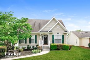 Winston-Salem house for rent - A house with a green front yard and a tree in front of it.