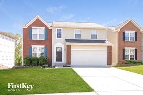 Morrow house for rent - a brick house with a white garage door and a lawn