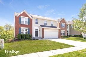 Morrow house for rent - a house with a white garage door in front of a lawn