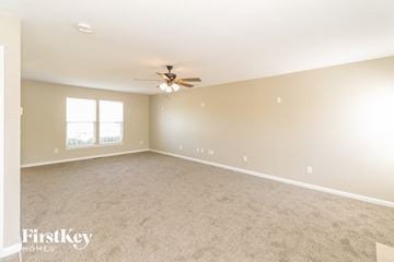 Morrow house for rent - a living room with carpet and a ceiling fan
