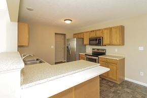 Morrow house for rent - a kitchen with an island and a stainless steel refrigerator