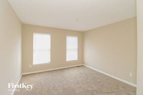 Morrow house for rent - a bedroom with two windows and beige carpet