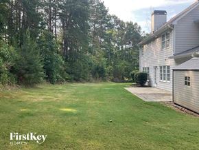 Dallas house for rent - a backyard with a yard and a house and some trees
